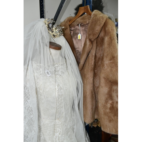 361 - A 1970S IVORY WEDDING DRESS AND VEIL, comprising a layered tulle skirt and fitted bodice, Princess l... 