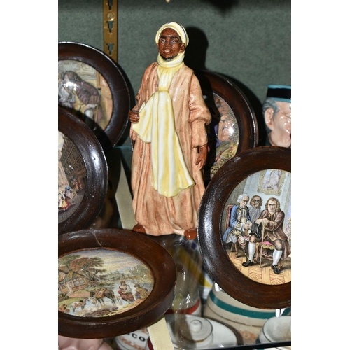 394 - A ROYAL DOULTON 'IBRAHIM' FIGURE AND SEVEN FRAMED PRATTWARE POT LIDS, comprising Royal Doulton Ibrah... 