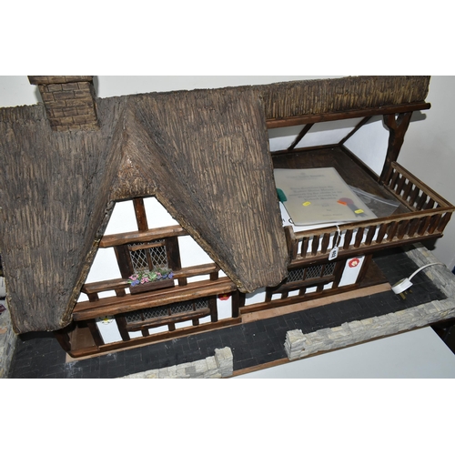 402 - A TUDOR STYLE DOLLS HOUSE BY ROBERT STUBBS, with a signed certificate of authenticity, three magneti... 