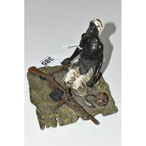 385 - A BERGMANN STYLE COLD PAINTED BRONZE OF AN ARMS DEALER, the figure kneeling on a rug with various we... 