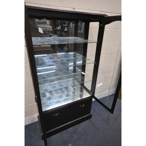 1398 - A MODERN MAHOGANY CABINET, with two glazed doors enclosing three glass shelves, above two cupboard d... 