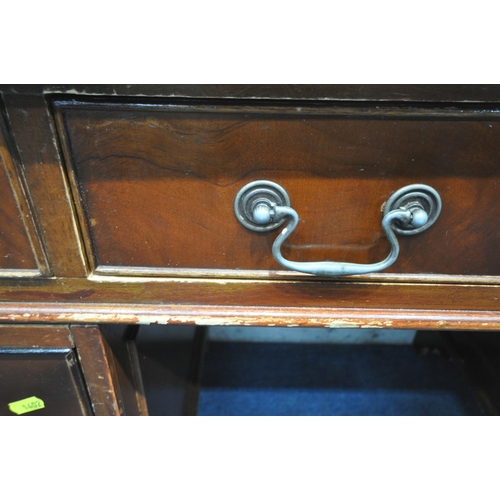 1402 - A REPRODUCTION MAHOGANY TWIN PEDESTAL DESK, with green tooled leather writing surface and an arrange... 