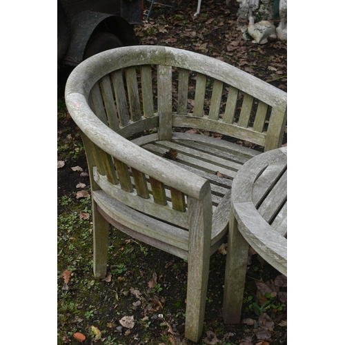 1012 - A PAIR OF WEATHERED TEAK BANANA ARMCHAIRS, and a matching table (condition report: weathered, no rot... 