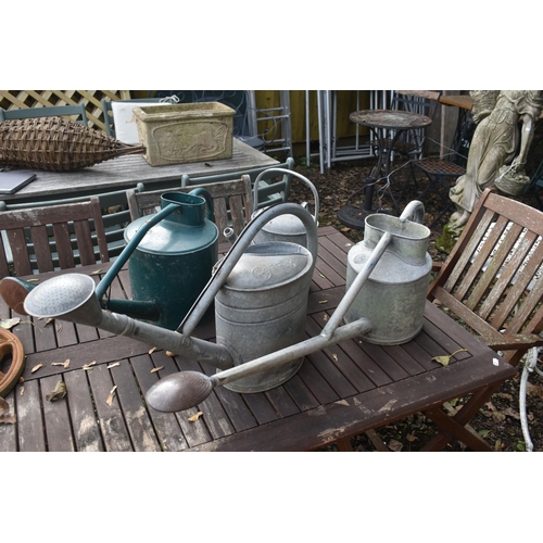 1020 - THREE VINTAGE GALVANISED WATERING CANS, one labelled HAWS of Stourbridge, another stamped BAT, and a... 