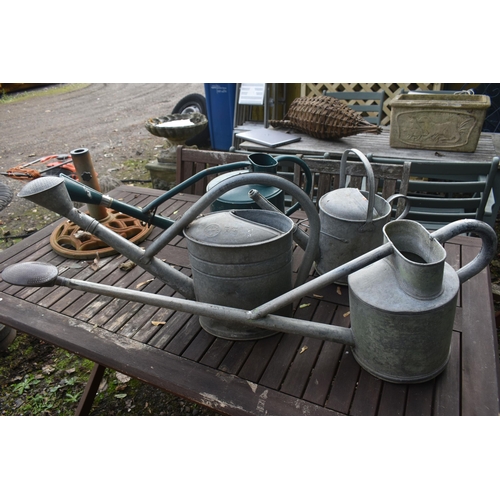 1020 - THREE VINTAGE GALVANISED WATERING CANS, one labelled HAWS of Stourbridge, another stamped BAT, and a... 