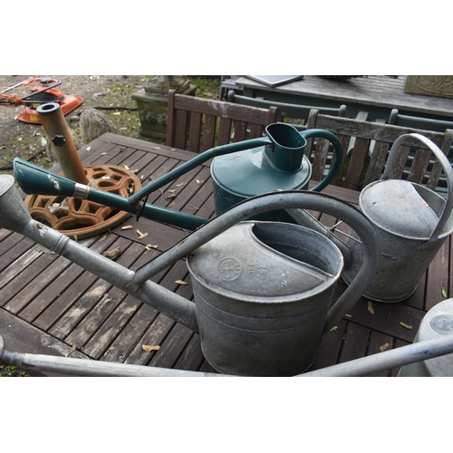 1020 - THREE VINTAGE GALVANISED WATERING CANS, one labelled HAWS of Stourbridge, another stamped BAT, and a... 