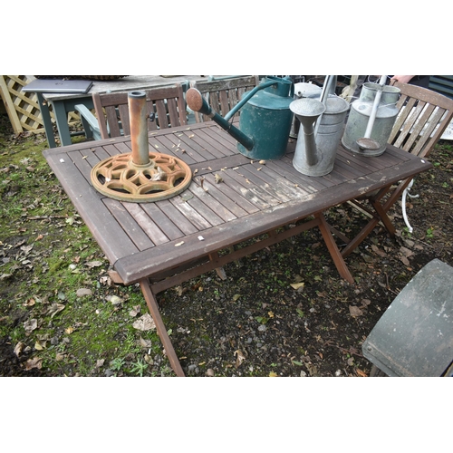 1021 - A STAINED TEAK FOLDING GARDEN TABLE, length 150cm x depth 87cm x height 73cm, three folding armchair... 