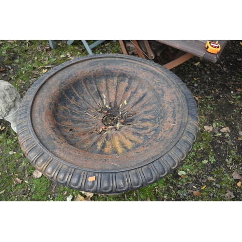 1022 - A CAST IRON URN OF A SHALLOW FORM, the circular campagna top on a turned and foliage design base, di... 