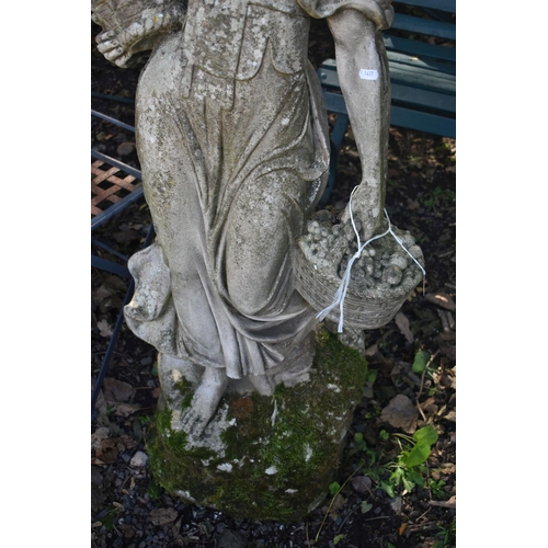 1027 - A WEATHERED COMPOSITE GARDEN STATUE, of a scantily lady carrying baskets, height 136cm (condition re... 