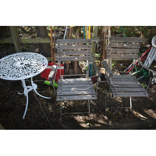 1031 - A PAIR OF IRON AND TEAK FOLDING ARMCHAIRS, along with a painted aluminium garden table (3)