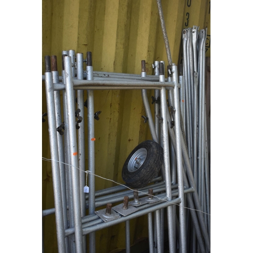 1034 -  A STEEL SCAFFOLDING TOWER, with nine sides including three base sections, twenty two connectin rail... 