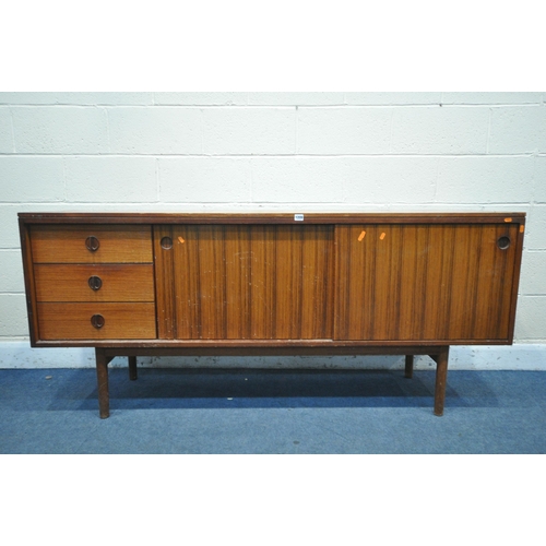 1395 - A GORDON RUSSELL ROSEWOOD SIDEBOARD, with three drawers to the left of cupboards, on circular sectio... 