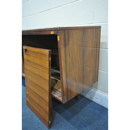 1395 - A GORDON RUSSELL ROSEWOOD SIDEBOARD, with three drawers to the left of cupboards, on circular sectio... 