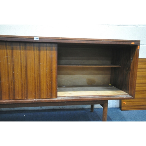 1395 - A GORDON RUSSELL ROSEWOOD SIDEBOARD, with three drawers to the left of cupboards, on circular sectio... 