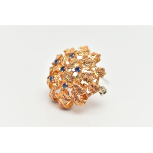 116 - A 14CT GOLD BROOCH, circular textured dome leaf brooch, set with six small circular cut blue sapphir... 