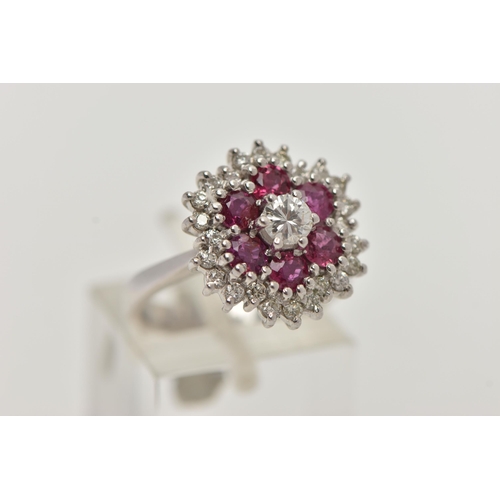 36 - A WHITE METAL RUBY AND DIAMOND CLUSTER RING, flower cluster set with a central round brilliant cut d... 