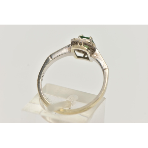 45 - A 9CT WHITE GOLD GEM SET RING, set with a central emerald, in a surround of round brilliant cut diam... 