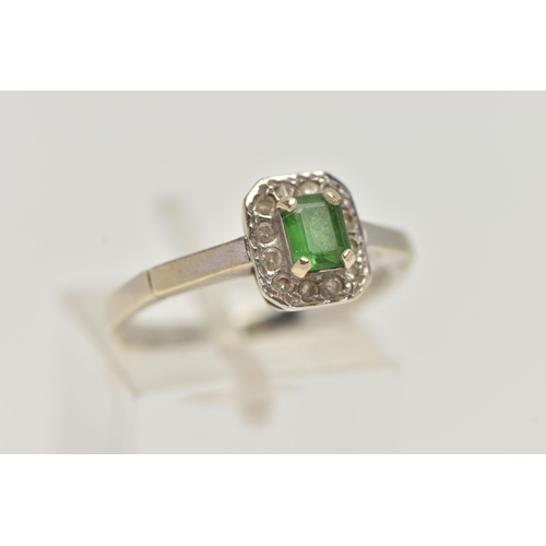 45 - A 9CT WHITE GOLD GEM SET RING, set with a central emerald, in a surround of round brilliant cut diam... 