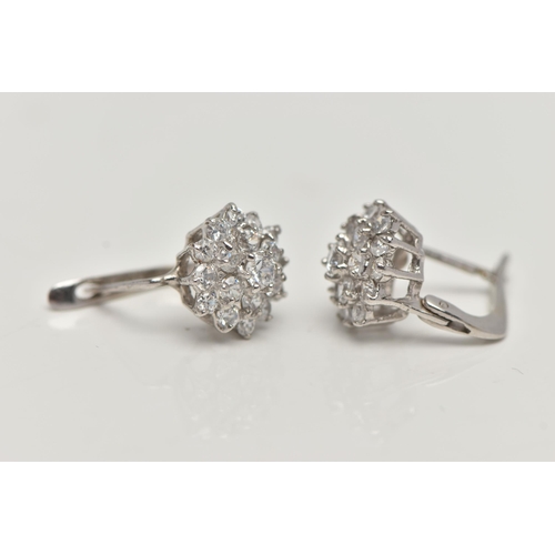 55 - A PAIR OF WHITE METAL CUBIC ZIRCONIA EARRINGS, cluster setting, fitted with posts and lever back fit... 