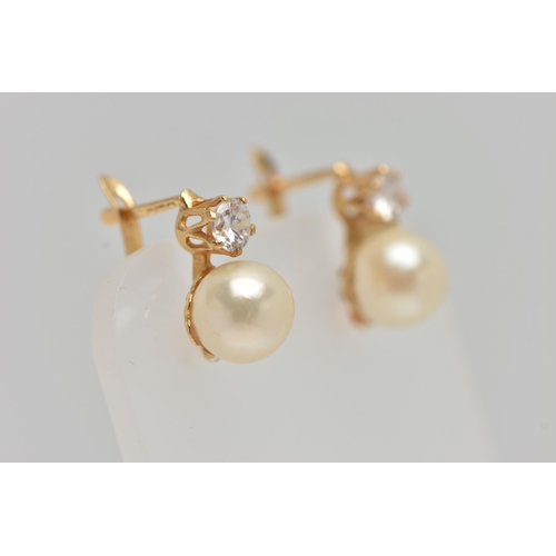 58 - A PAIR OF YELLOW METAL EARRINGS, each earring set with an imitation pearl and a circular cut cubic z... 