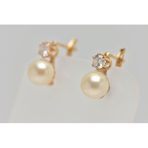 58 - A PAIR OF YELLOW METAL EARRINGS, each earring set with an imitation pearl and a circular cut cubic z... 