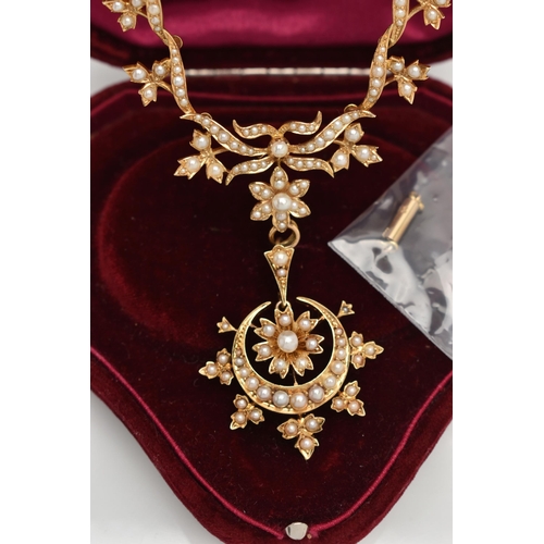 73 - AN EARLY 20TH CENTURY GOLD AND SEED PEARL NECKLACE, a central floral piece leading on to branches an... 