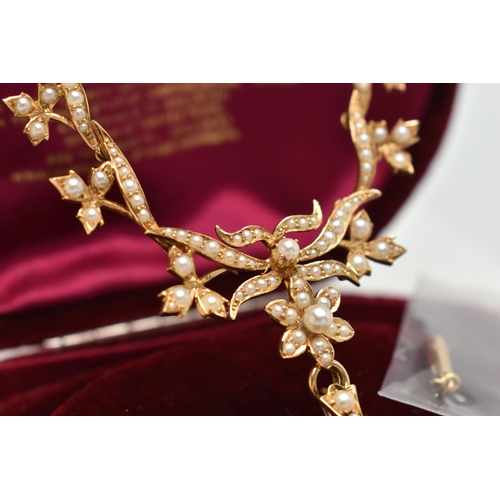 73 - AN EARLY 20TH CENTURY GOLD AND SEED PEARL NECKLACE, a central floral piece leading on to branches an... 