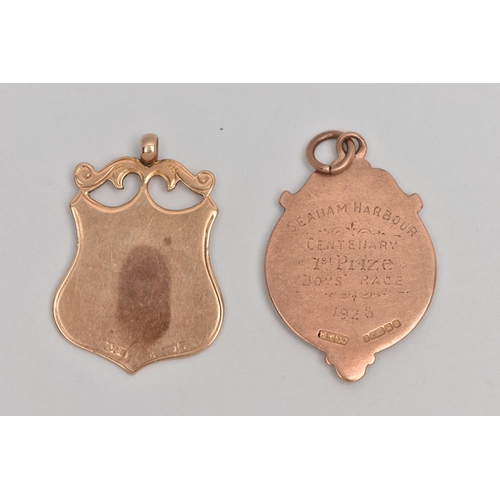 123 - TWO EARLY 20TH CENTURY 9CT GOLD MEDALLIONS, one of circular outline the other of shield shape outlin... 