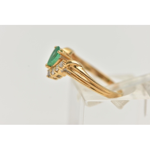 129 - AN EMERALD AND DIAMOND RING, the pear shape emerald with a v-shape line of brilliant cut diamonds be... 