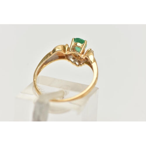 129 - AN EMERALD AND DIAMOND RING, the pear shape emerald with a v-shape line of brilliant cut diamonds be... 