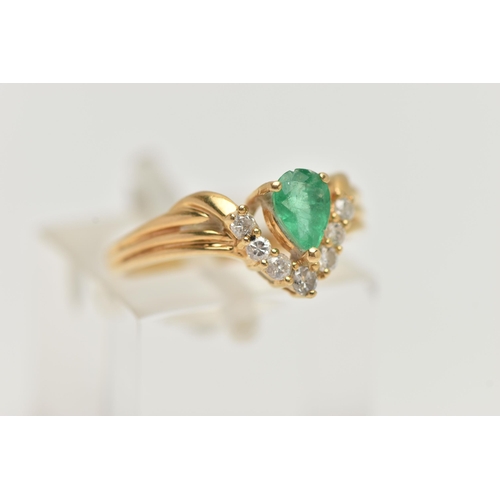 129 - AN EMERALD AND DIAMOND RING, the pear shape emerald with a v-shape line of brilliant cut diamonds be... 