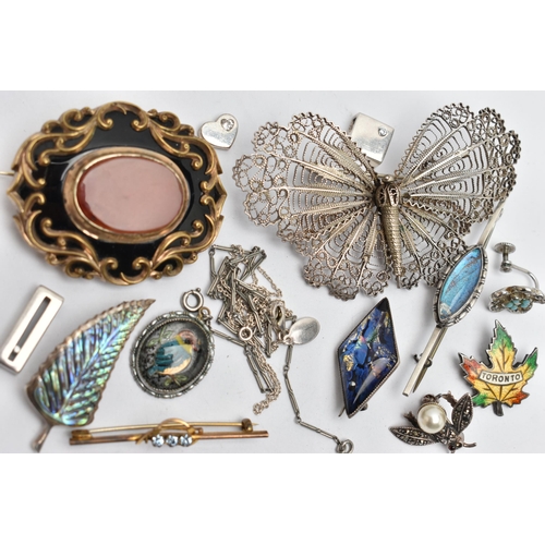 146 - A SMALL BAG OF BROOCHES, to include a gold plated oval brooch, set with a central carnelian inlay, b... 