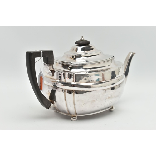 195 - A GEORGE III SILVER TEAPOT, polished form, worn engraved crests to either side, on four ball feet, f... 