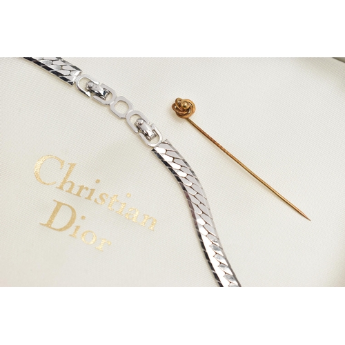 203 - A 'CHRISTIAN DIOR' NECKLACE AND YELLOW METAL STICK PIN, a bi colour necklace with a cross over desig... 