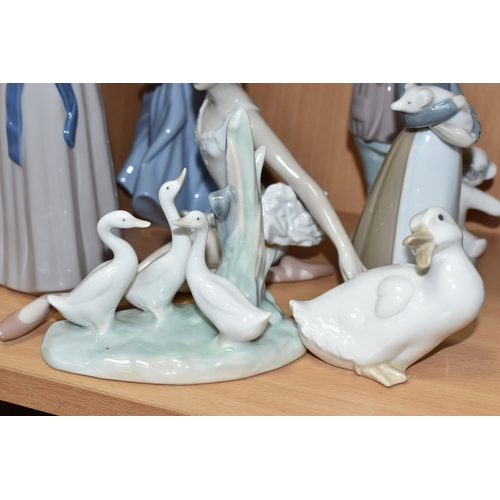 405 - A GROUP OF LLADRO AND NAO FIGURES, comprising Lladro: Trying on a Straw Hat, model no 5011, sculptor... 