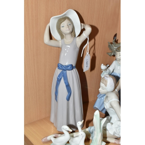 405 - A GROUP OF LLADRO AND NAO FIGURES, comprising Lladro: Trying on a Straw Hat, model no 5011, sculptor... 