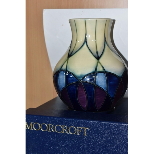 425 - A BOXED MOORCROFT POTTERY VASE, 'Indigo' pattern, designed by Emma Bossons, c.1999, decorated with g... 