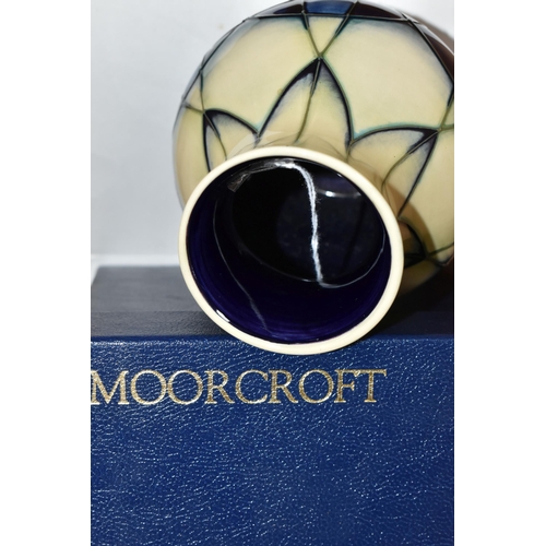 425 - A BOXED MOORCROFT POTTERY VASE, 'Indigo' pattern, designed by Emma Bossons, c.1999, decorated with g... 