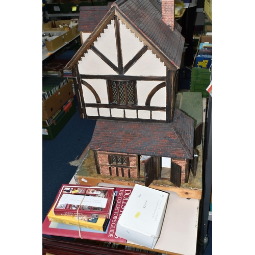 551 - A WOODEN DOLLS HOUSE, modelled as an Elizabethan style half-timbered house, front opening to reveal ... 