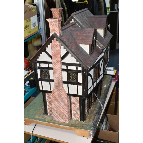 551 - A WOODEN DOLLS HOUSE, modelled as an Elizabethan style half-timbered house, front opening to reveal ... 