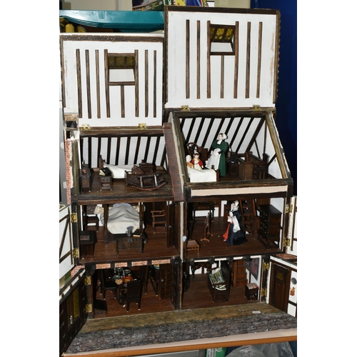 551 - A WOODEN DOLLS HOUSE, modelled as an Elizabethan style half-timbered house, front opening to reveal ... 