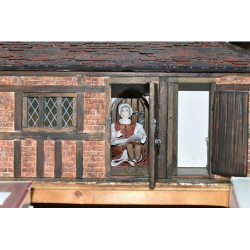 551 - A WOODEN DOLLS HOUSE, modelled as an Elizabethan style half-timbered house, front opening to reveal ... 