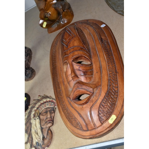 599 - CARVED WOODEN DECORATIVE ITEMS ETC, comprising three African tribal carvings, tallest a family group... 