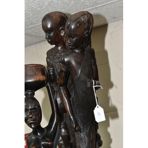 599 - CARVED WOODEN DECORATIVE ITEMS ETC, comprising three African tribal carvings, tallest a family group... 