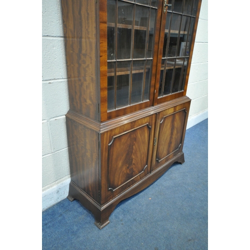 1424 -  A BEVAN FUNNELL MAHOGANY BOOKCASE, with two glazed doors and two cupboard doors, width 106cm x dept... 