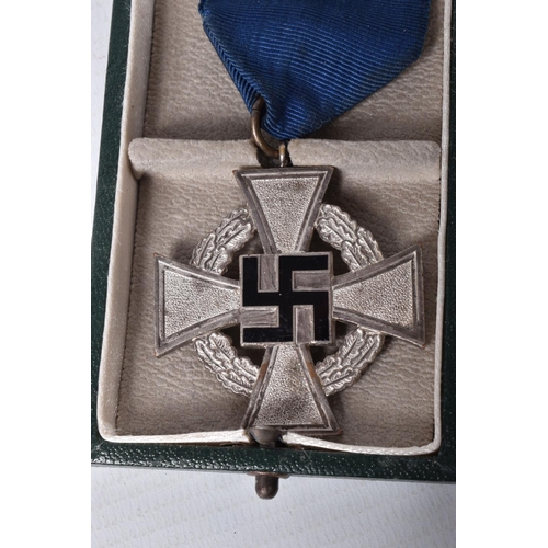 413 - A CASED GERMAN 25 YEAR FAITHFUL SERVICE MEDAL, this is silver in colour and comes with its blue ribb... 