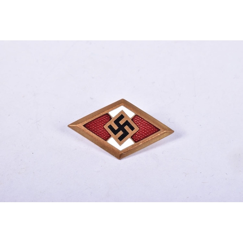 420 - A GERMAN THIRD REICH GOLD HITLER YOUTH BADGE, it has red, white and black enamel to the front with S... 