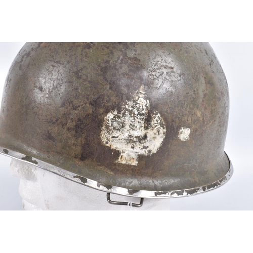 461 - A USA ARMY STEEL HELMET, this is khaki green in colour and traces of black are coming through the pa... 