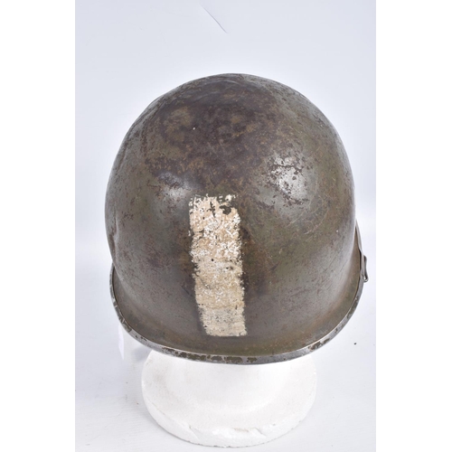 461 - A USA ARMY STEEL HELMET, this is khaki green in colour and traces of black are coming through the pa... 