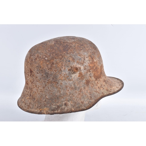 462 - A WWI ERA GERMAN BATTLE DAMAGED HELMET, this has damage to the top in two places and has some light ... 